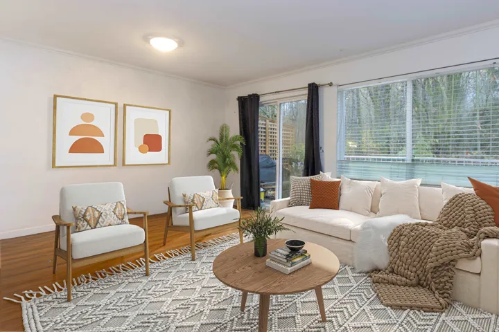 Living area with wood finished floors and ornamental molding