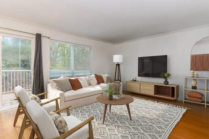 Living room with wood finished floors and ornamental molding