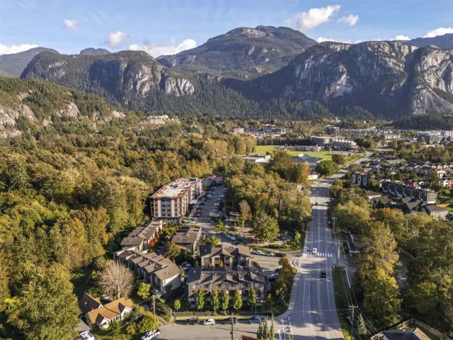 Aerial view of property and surrounding area with a mountain backdrop