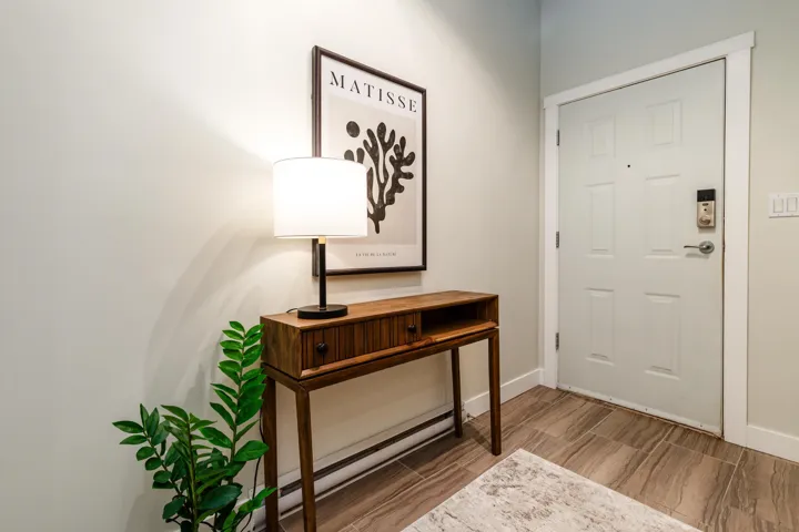 Entryway featuring baseboards and wood finished floors