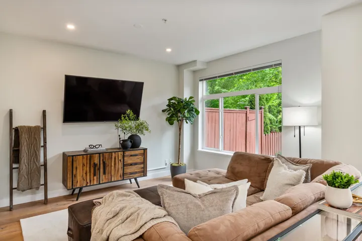 Living area featuring wood finished floors, recessed lighting, and baseboards