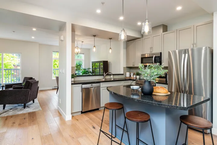 Kitchen with stainless steel appliances, a breakfast bar, backsplash, plenty of natural light, and recessed lighting