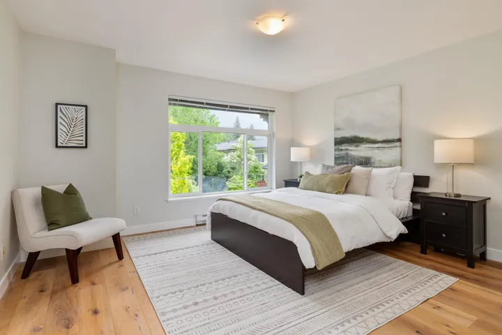 Bedroom featuring light wood-type flooring, baseboards, and a baseboard radiator