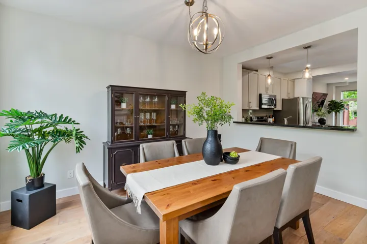 Dining area featuring baseboards, light wood-style flooring, and a chandelier