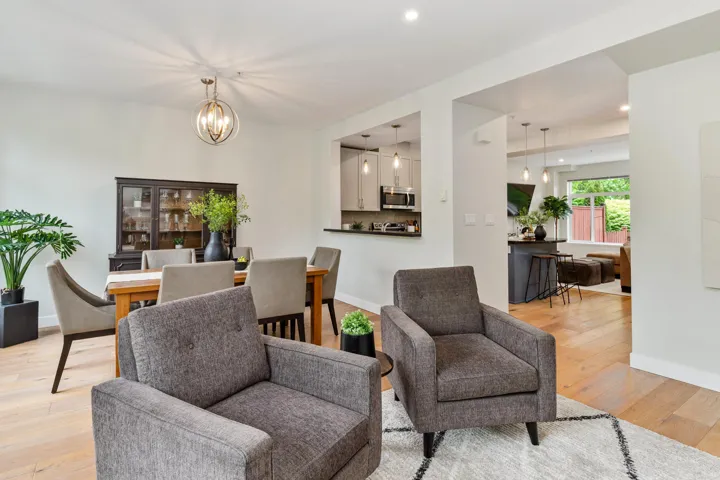 Living room featuring a chandelier, light wood-type flooring, and recessed lighting