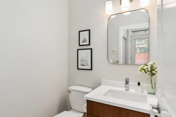 Half bathroom with toilet and vanity