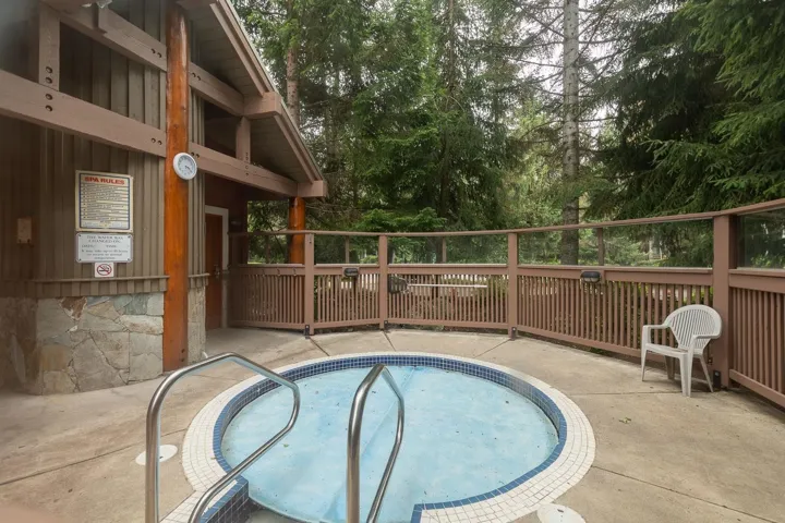 Circular outdoor spa with integrated steps and handrails