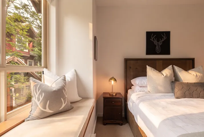 Integrated window bench seating with a wood frame and neutral-toned cushion