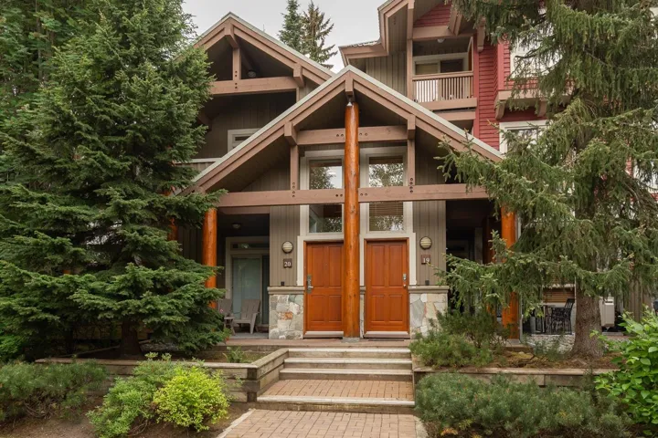Stone and wood-clad exterior with prominent gabled roofs