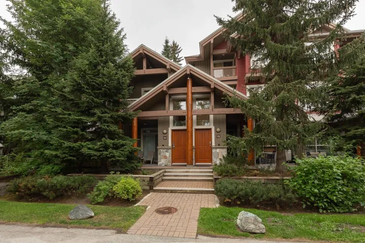 Wood-siding exterior with natural wood trim and stone accents