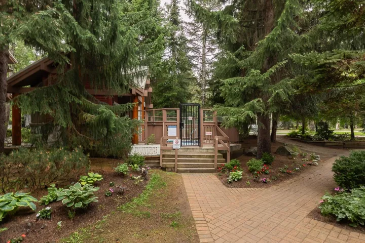 Wood-sided building with covered patio and substantial wooden support beams
