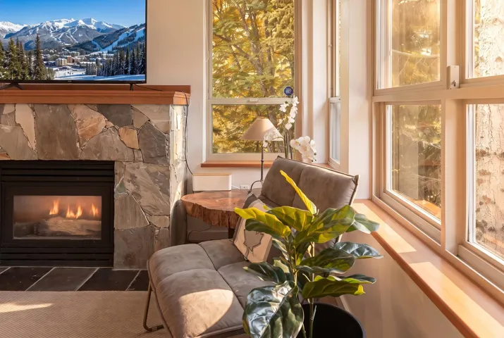 Stone-clad fireplace with a wood mantel