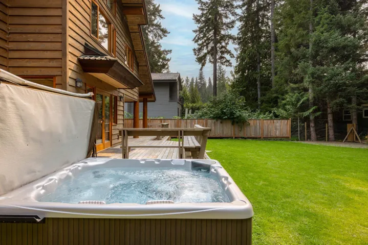 View of yard featuring a hot tub and a deck