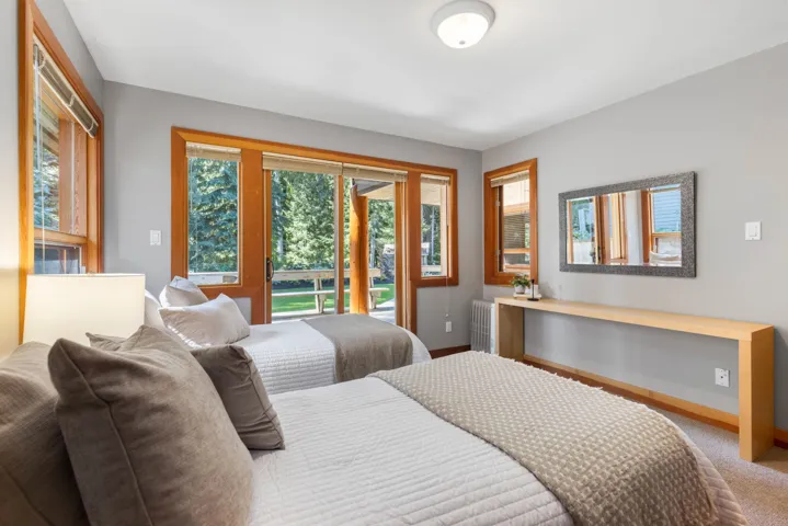Bedroom with access to outside, radiator, and carpet