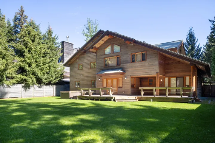 Back of house featuring a wooden deck and a chimney