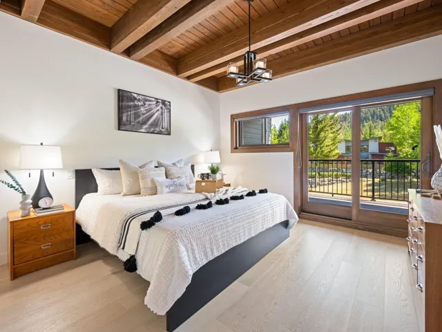 Bedroom featuring a wood ceiling with exposed beams, access to exterior, a chandelier, and light wood-type flooring