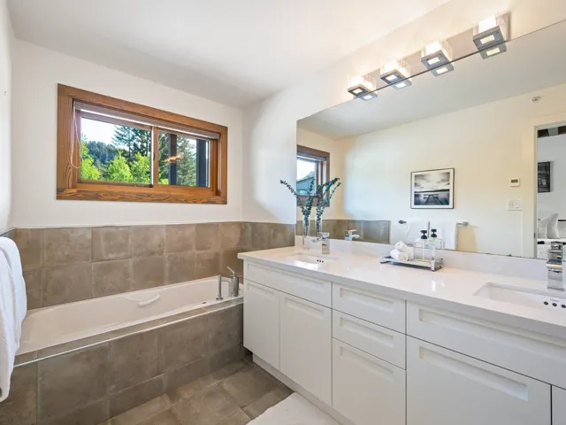 Bathroom featuring double vanity, a bath, and tile patterned floors