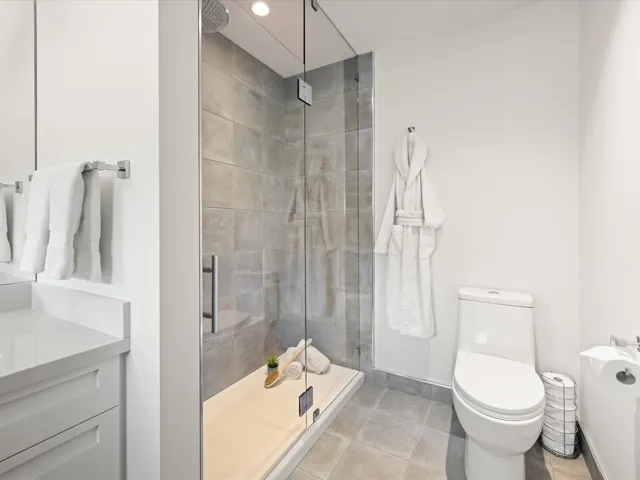 Full bath with a shower stall, tile patterned floors, and vanity