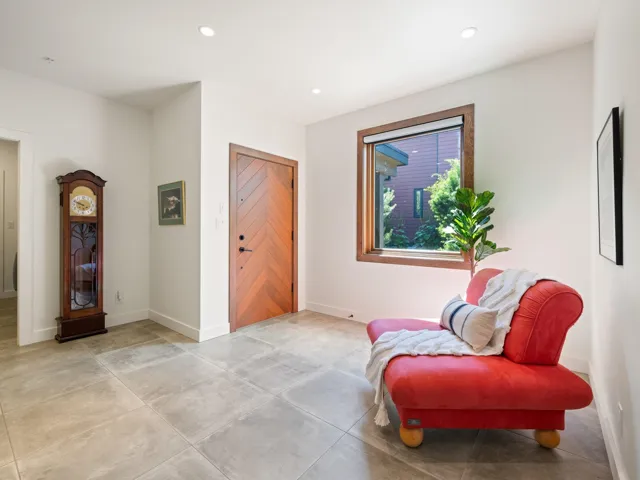 Sitting room with recessed lighting and concrete flooring