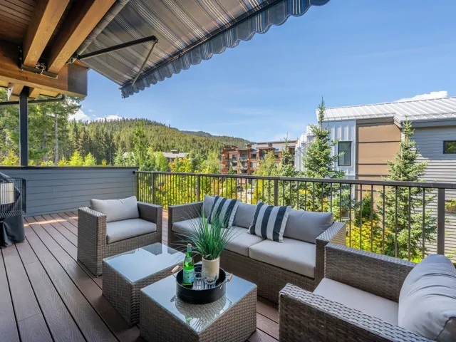 Wooden terrace with an outdoor living space and a mountain view