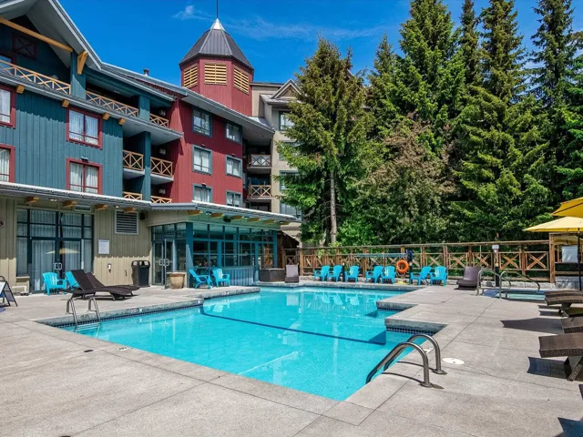 Community pool with fence and a patio area