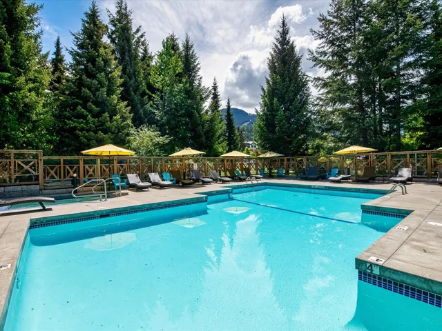 View of pool with a fenced in pool, a mountain view, fence, and a patio