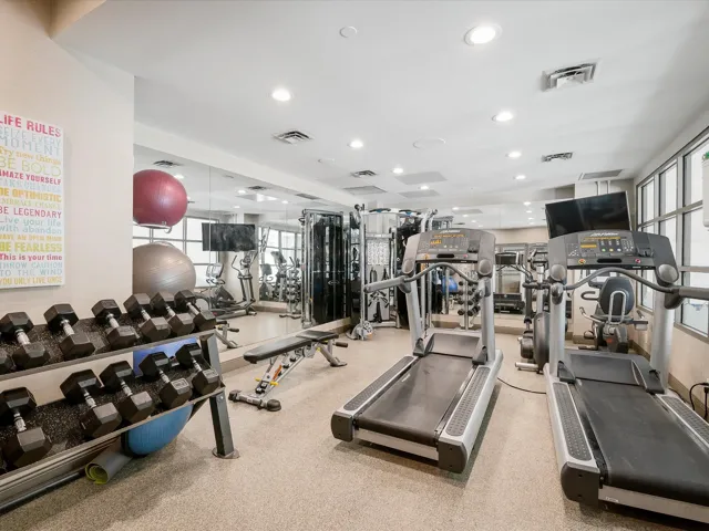 Exercise room with visible vents and recessed lighting