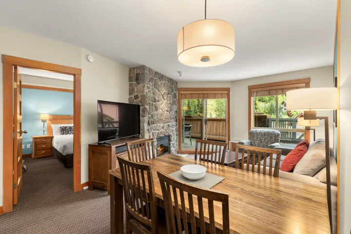 Dining area featuring wood-finish flooring and a drum pendant light