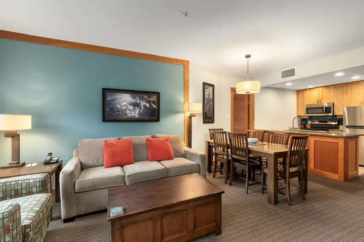 Open-concept living area featuring a kitchen, dining space, and living room