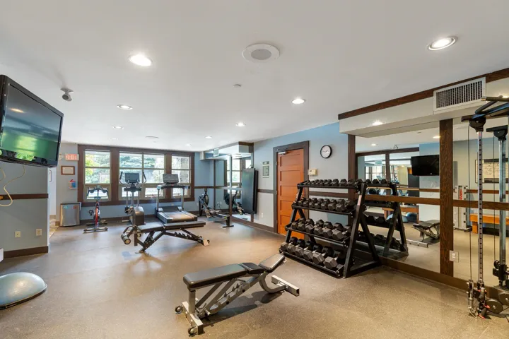 Fitness area featuring recessed lighting and a mounted television
