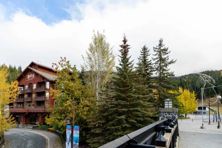 Mountain-style architecture with a multi-level facade, individual balconies, and prominent gables