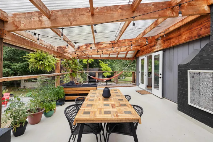 View of patio / terrace with outdoor dining space, a pergola, and french doors