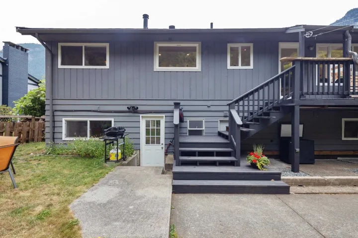 Rear view of house featuring stairway
