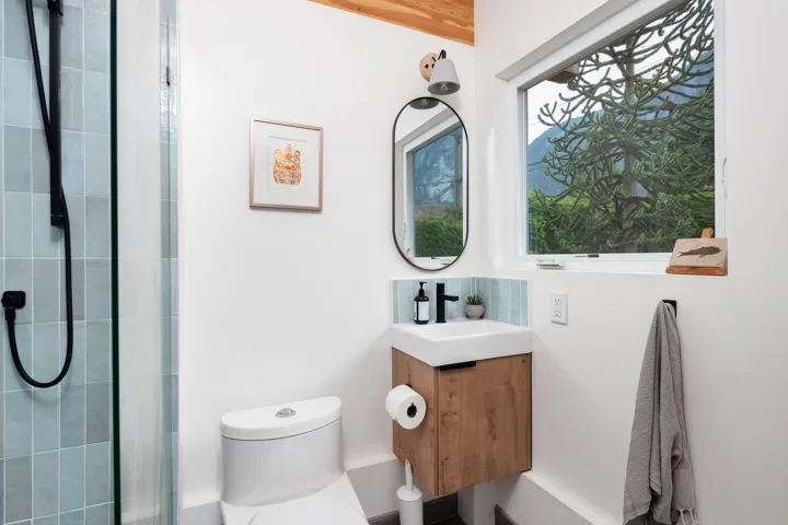 Bathroom featuring a tile shower and vanity