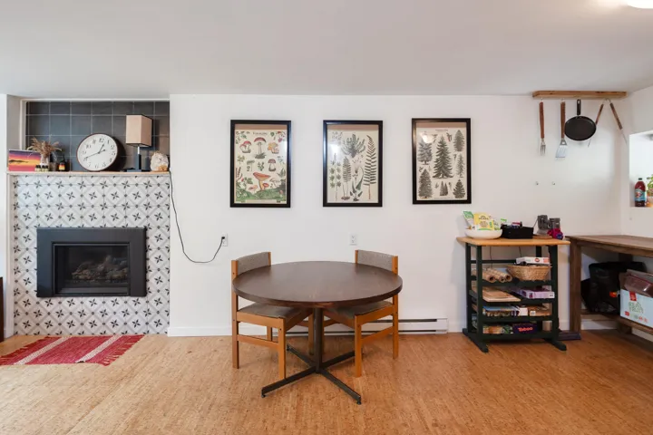 Dining room featuring a tile fireplace and baseboards