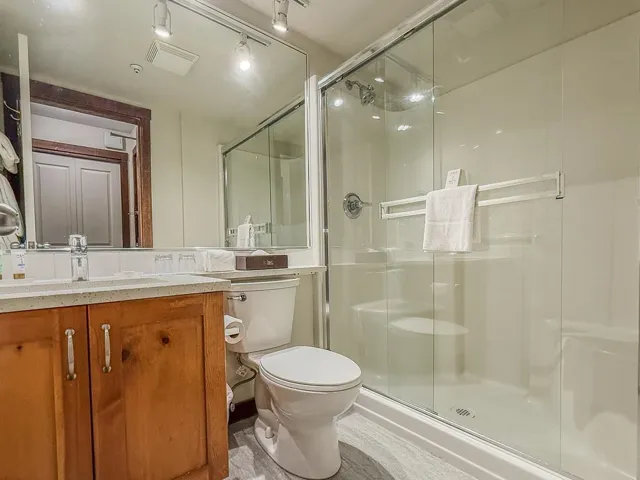 Bathroom featuring vanity and a shower stall
