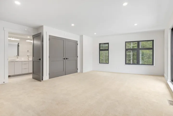 Unfurnished bedroom featuring light colored carpet and recessed lighting