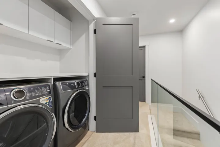 Laundry area with washing machine and dryer, recessed lighting, and light carpet