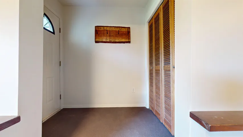Hallway with baseboards and carpet floors