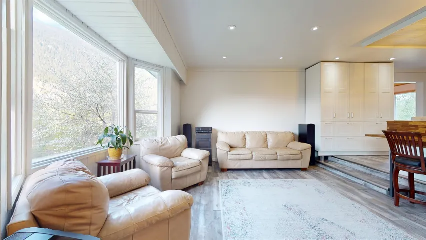 Living area with recessed lighting and light wood-style floors