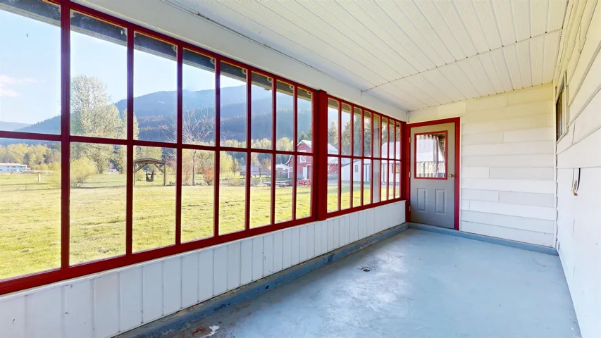 Unfurnished sunroom with a mountain view and a wealth of natural light