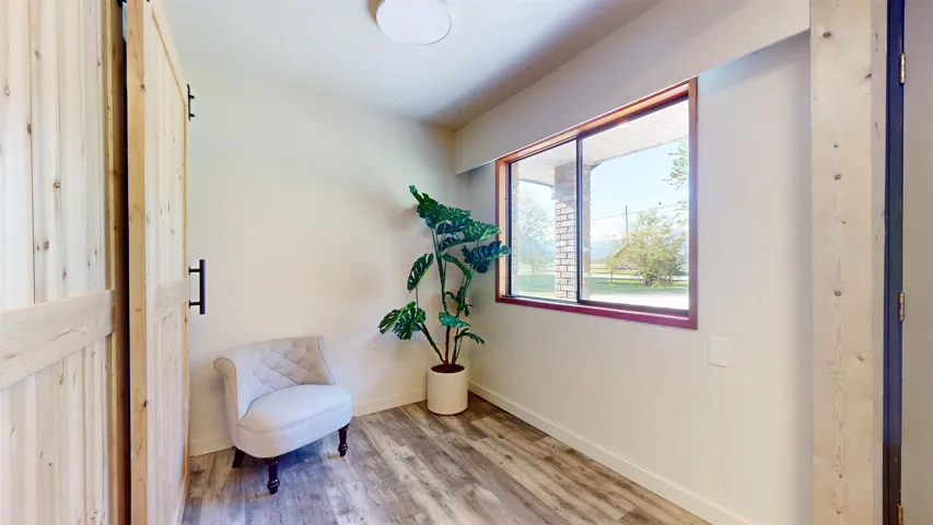 Sitting room with baseboards and light wood finished floors
