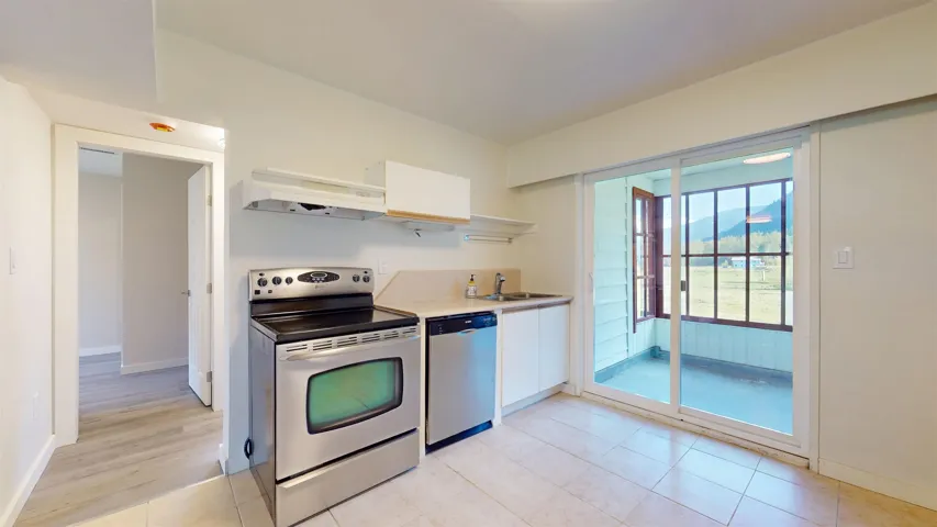 Kitchen featuring white cabinetry, open shelves, a sink, appliances with stainless steel finishes, and under cabinet range hood