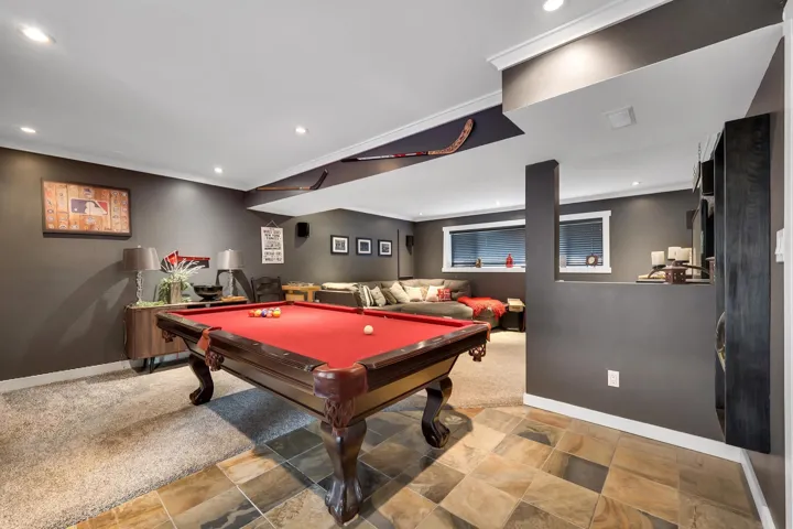 Recreation room featuring a billiards table with a red felt top, recessed lighting, and a mix of slate tile and carpet flooring