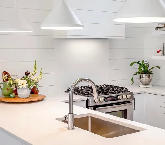Modern kitchen featuring white shiplap walls, recessed lighting, and a skylight