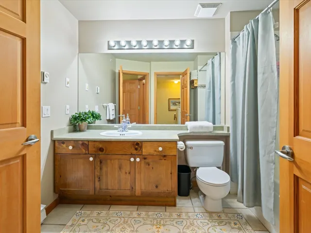 Full bathroom with vanity and tile patterned floors