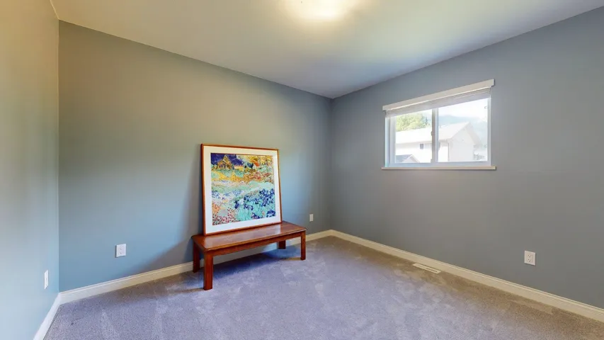 Carpeted spare room with baseboards