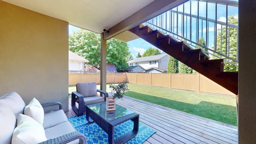 Wooden deck featuring an outdoor hangout area and stairway