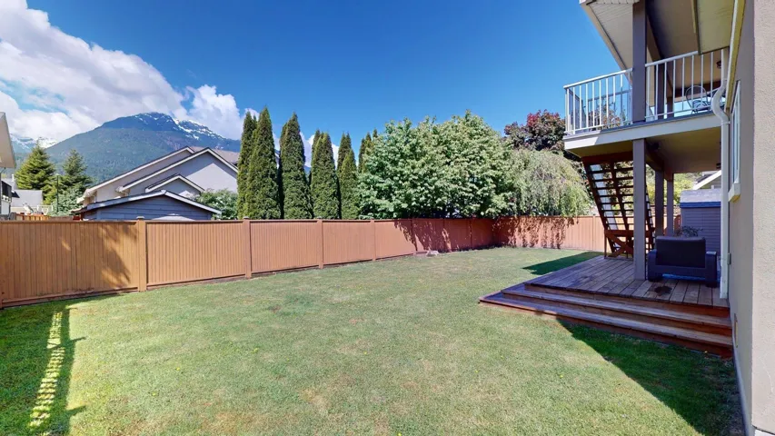 View of yard with stairway and a deck with mountain view