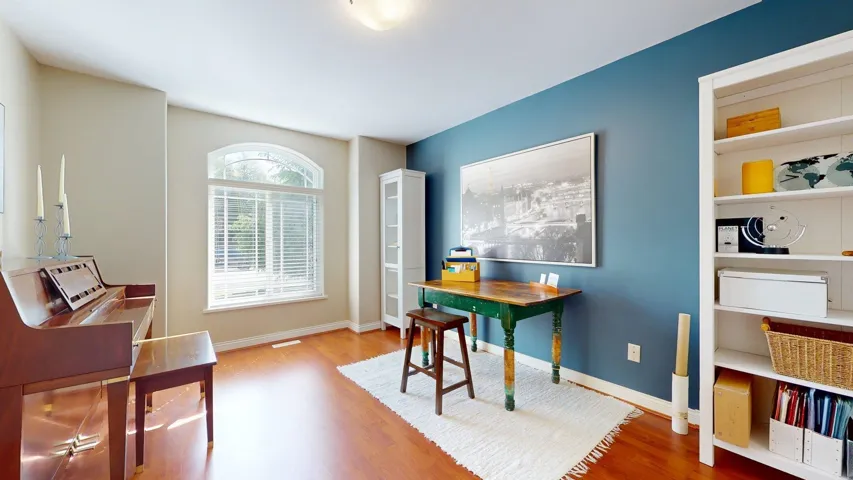 Office space with wood finished floors and baseboards
